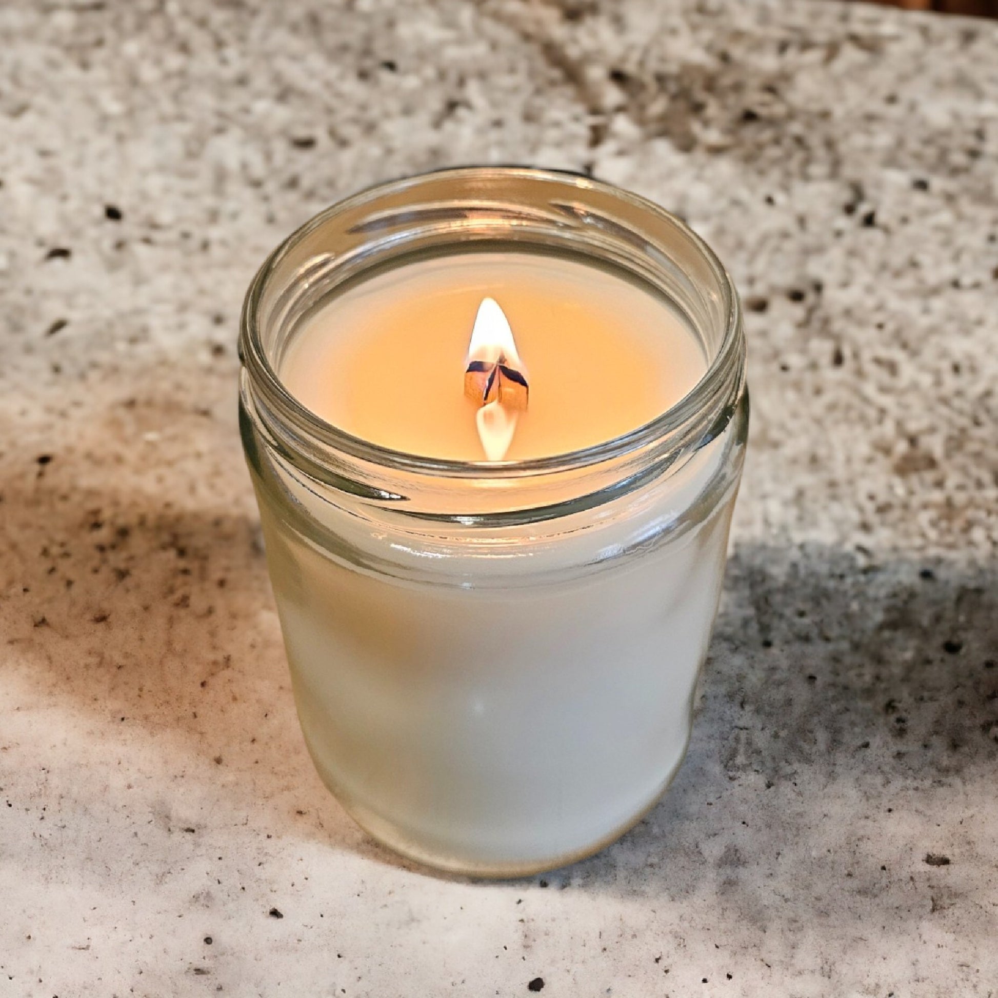 a lit candle sitting on top of a table